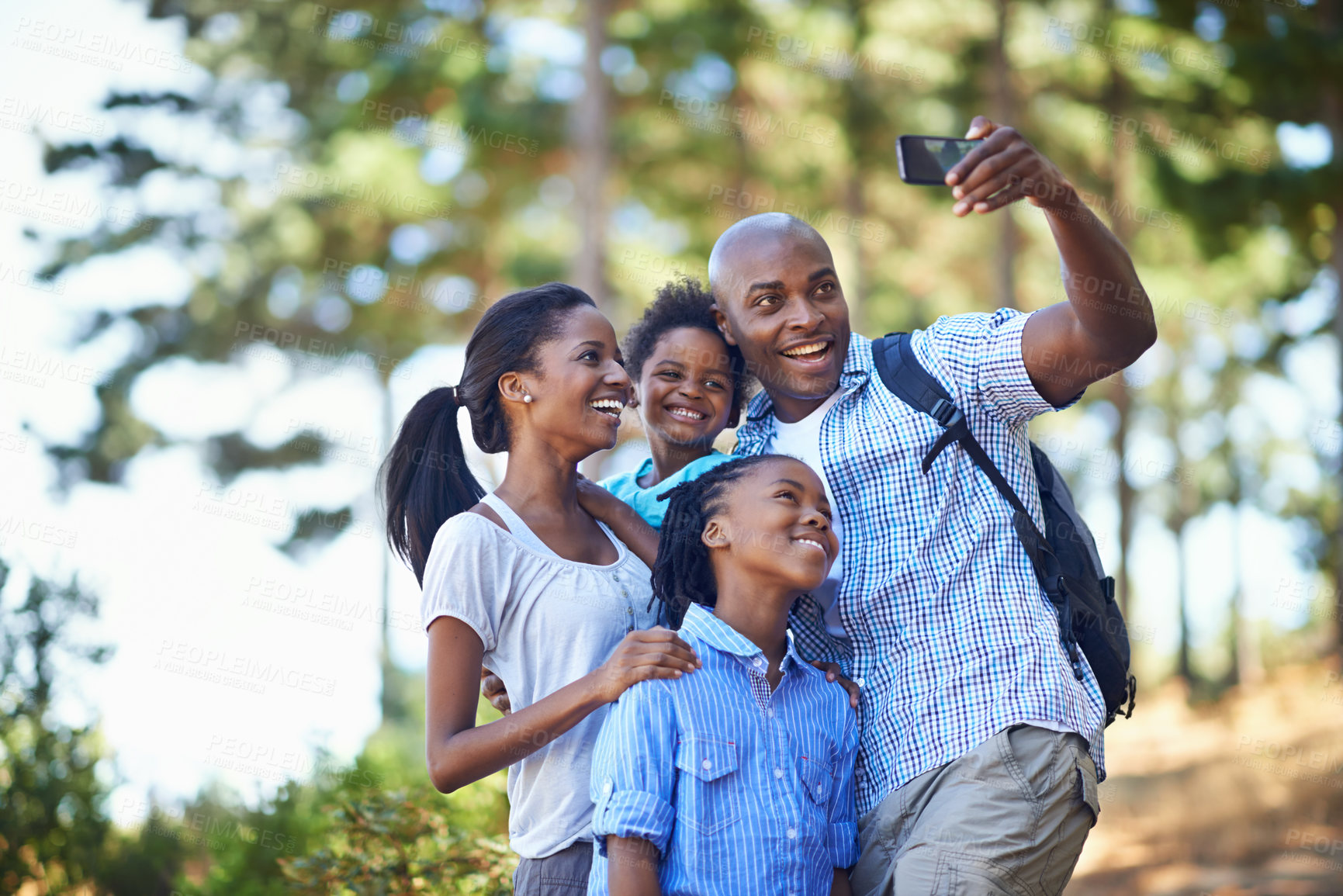 Buy stock photo Selfie, love and a black family hiking in the forest together for travel, freedom or summer vacation. Nature, fitness or wellness with a mother, father and children taking a photograph in the woods