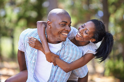 Buy stock photo Piggyback, laughing or happy black couple in forest to relax or bond on holiday vacation together in nature. Wellness, hug or African woman with smile or man in woods hiking on outdoor park adventure