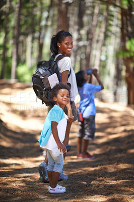 Buy stock photo Shot of a mother and her two children taking a walk in the woods