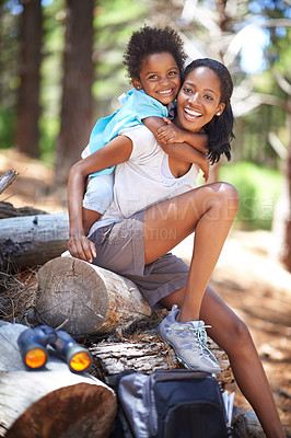 Buy stock photo Shot of a mother about to carry her daughter on her shoulders while out hiking