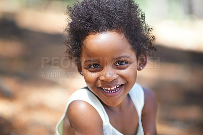 Buy stock photo Portrait of an adorable little girl smiling at the camera while enjoying a day outdoors