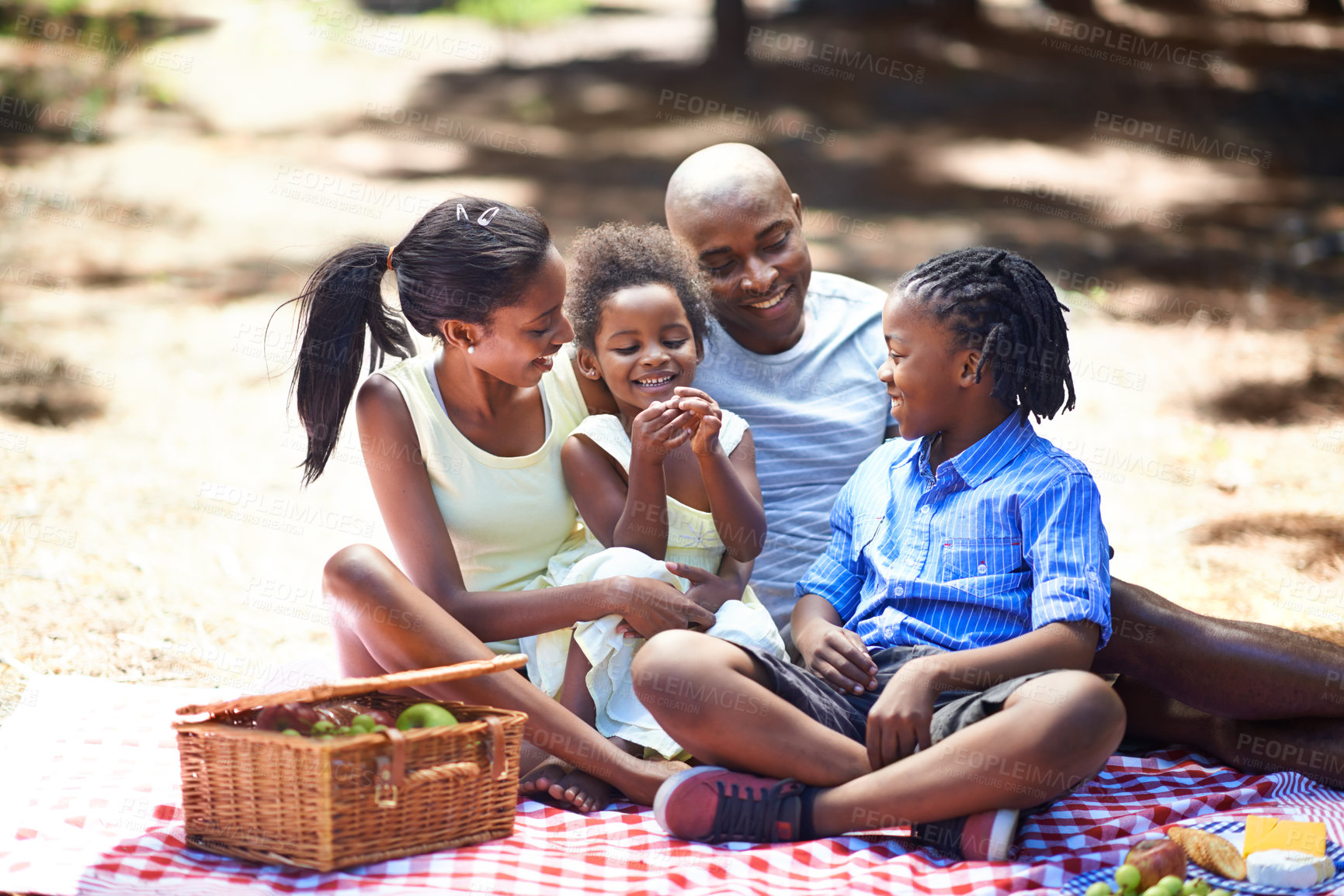 Buy stock photo Shot of a family enjoying a picnic in the woods