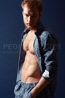 Buy stock photo Fashion, thinking or ginger model with body in studio on a blue background wearing an open unbuttoned shirt. Man, abs or handsome male person posing on color wall for masculine style with six pack