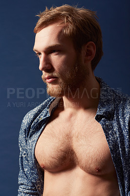 Buy stock photo Fashion, thinking or model with chest in studio on a blue background wearing an open unbuttoned shirt. Ginger, body or handsome male person posing on color wall for masculine style, health or fitness