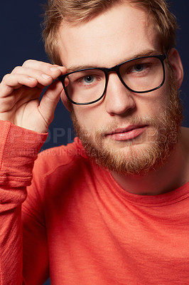 Buy stock photo Cropped view of a serious young man wearing hipster glasses