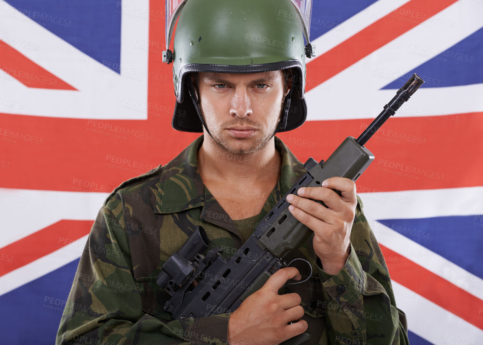 Buy stock photo Military, Britain and gun with portrait of man in studio for war, conflict and patriotic. Army, surveillance and security with person and rifle on uk flag for soldier, battlefield or veteran training