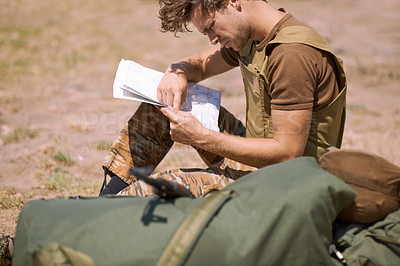 Buy stock photo Man with map on battlefield, planning battle location or tactical operation goals for mission in war. Soldier is outdoor at military base camp, check strategy paperwork with army target and attack