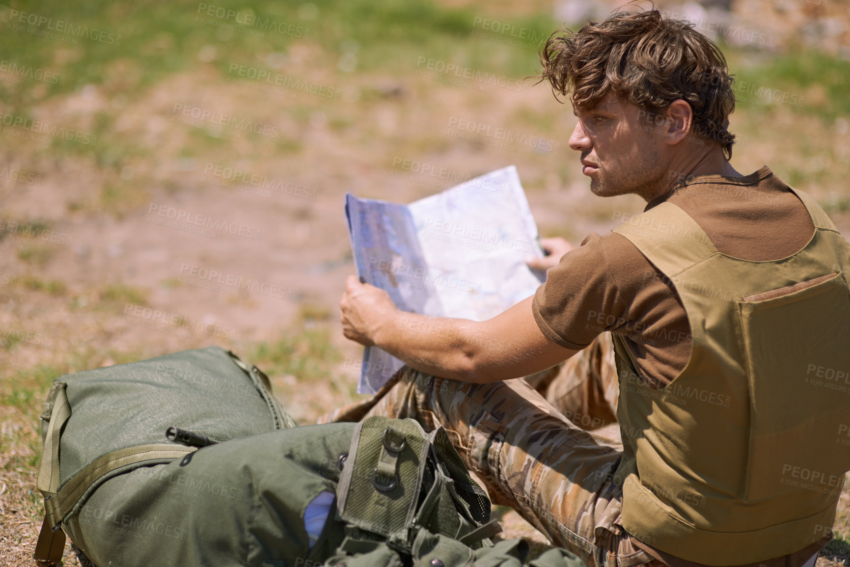 Buy stock photo Soldier with map on battlefield, planning battle location or tactical operation goals for mission in war. Man is outdoor at military base camp, check strategy paperwork with army target and attack