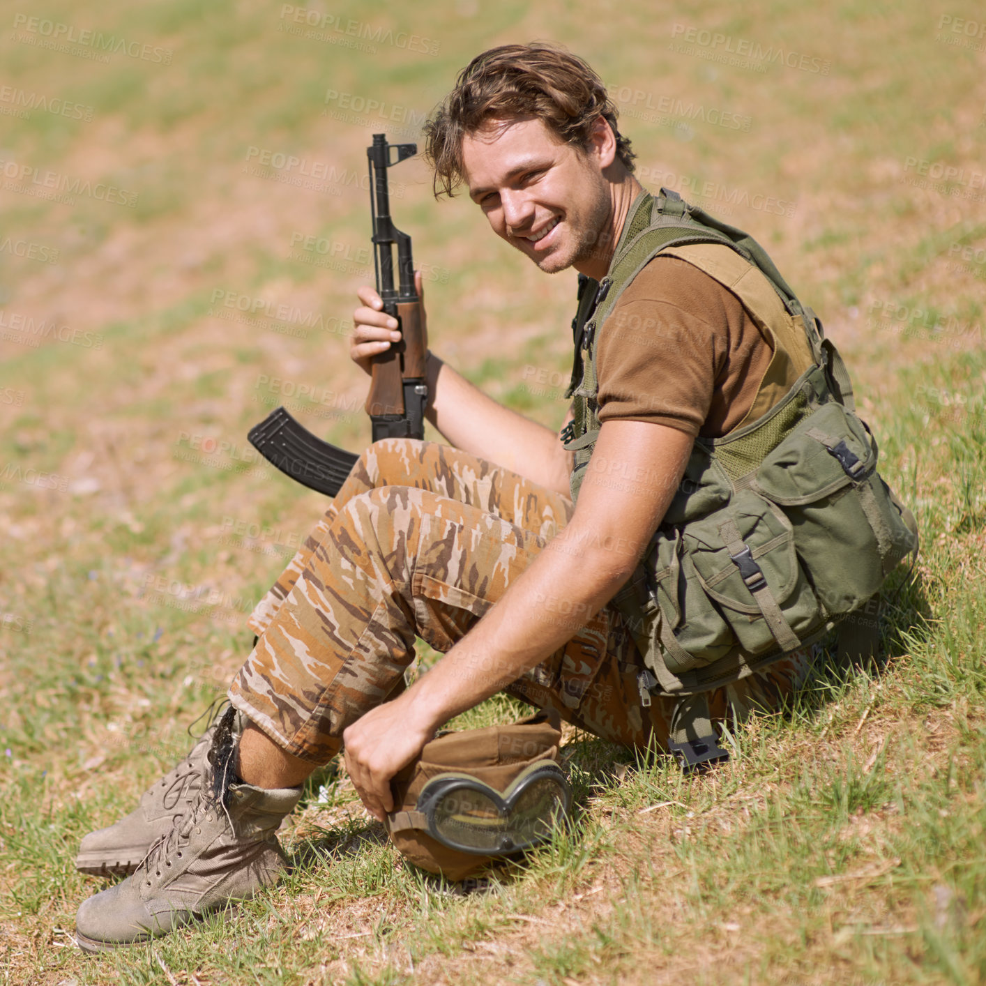 Buy stock photo Military, smile and nature with man in and gun for war, conflict and patriotism. Army, surveillance and security with young person and rifle training on grass for soldier, battlefield and veteran