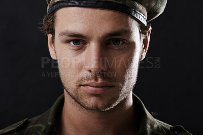 Buy stock photo Shot of a young man in military fatigues