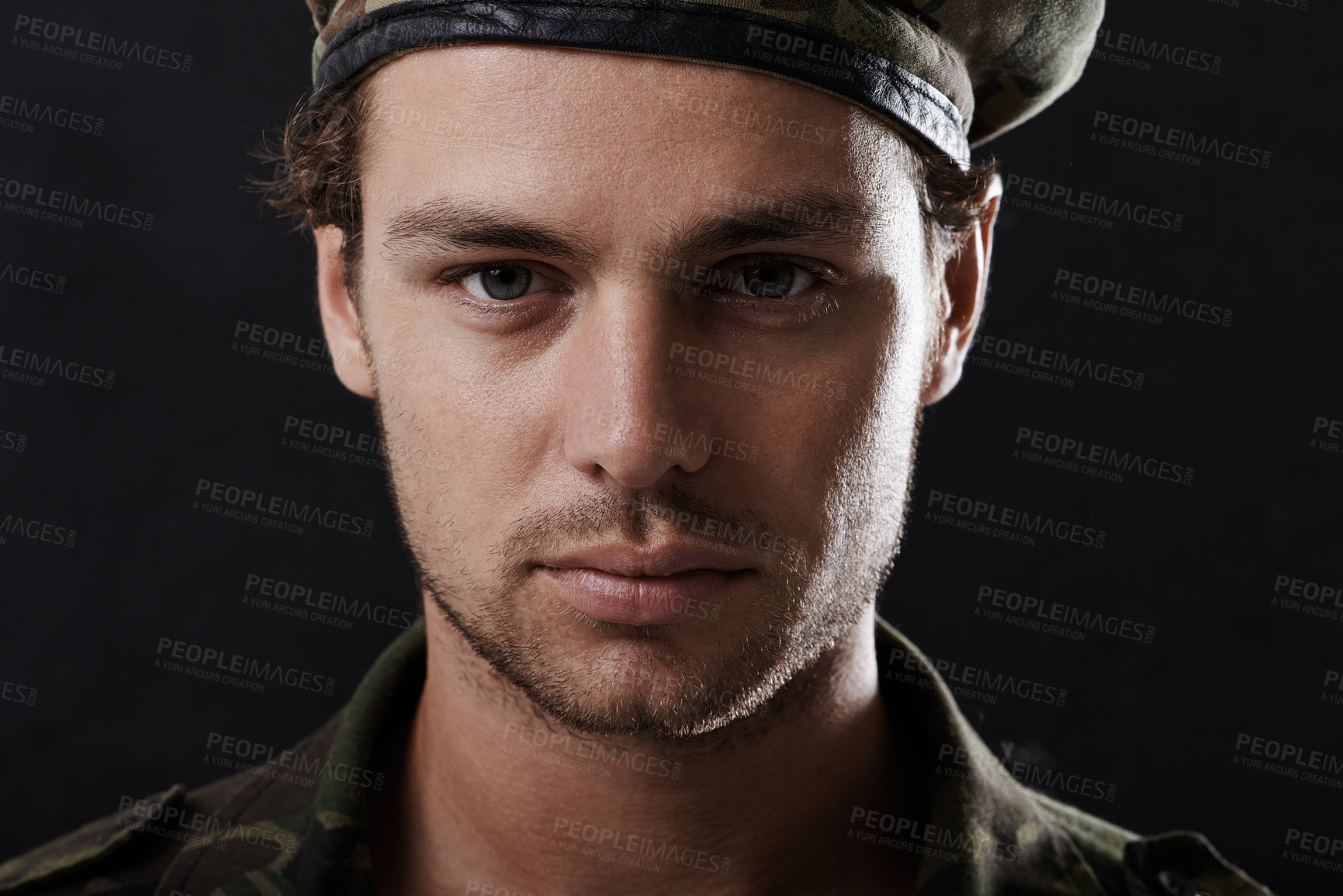 Buy stock photo Shot of a young man in military fatigues