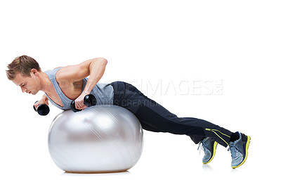 Buy stock photo Shot of a man balancing on an exercise ball lifting weights