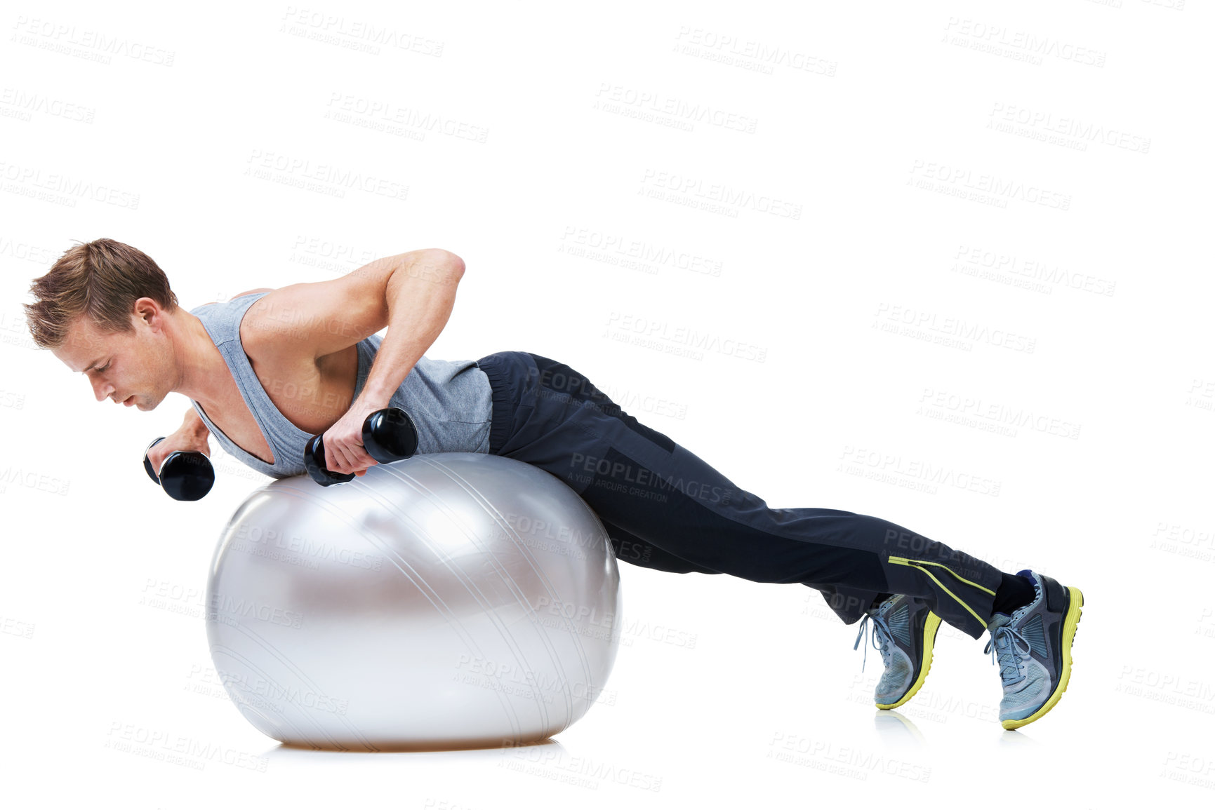 Buy stock photo Shot of a man balancing on an exercise ball lifting weights