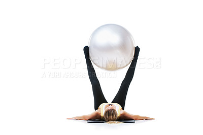 Buy stock photo Shot of a female holding an exercise ball up with her legs