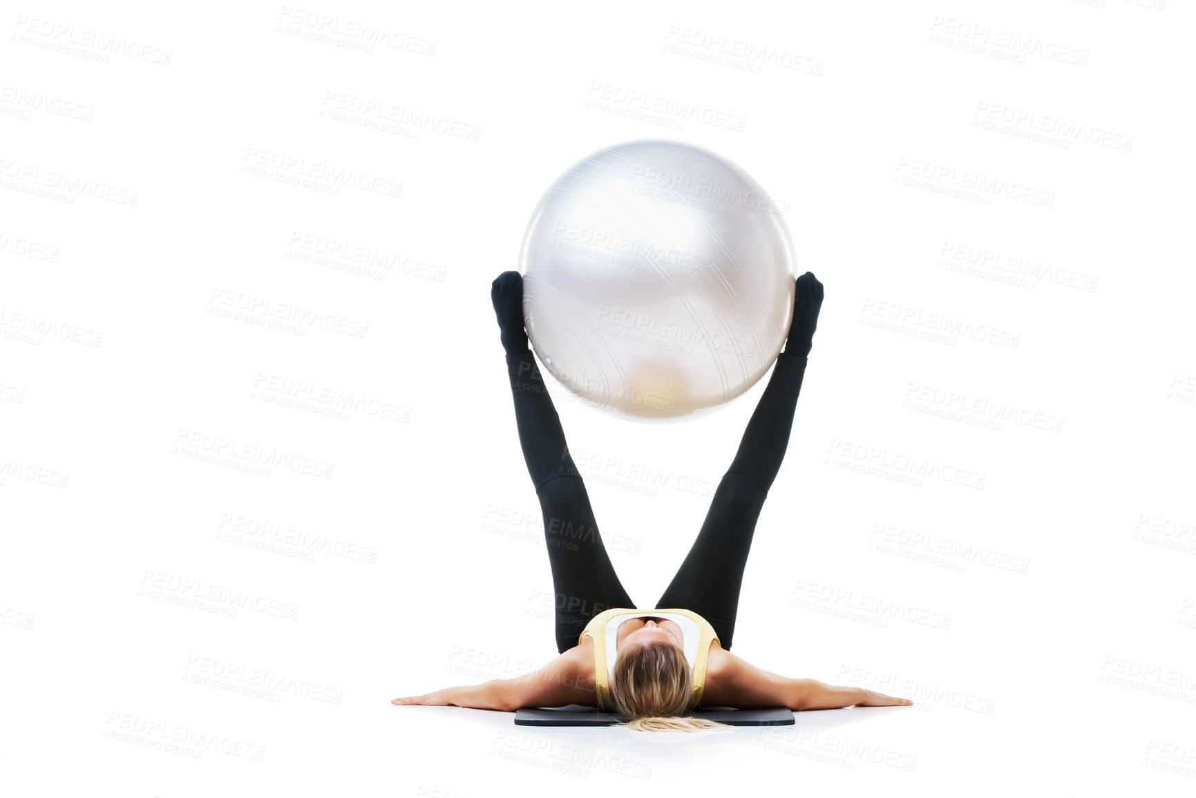 Buy stock photo Shot of a female holding an exercise ball up with her legs