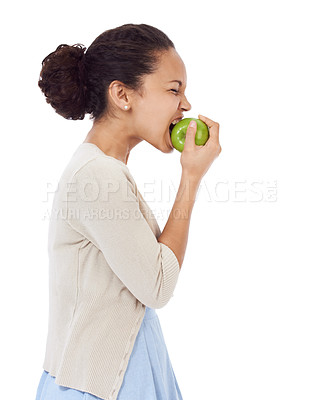 Buy stock photo Woman, eating apple and healthy food choice for detox, dental health and wellness on a white background. Profile of a young person biting a green fruit for nutrition, strong teeth or vegan in studio