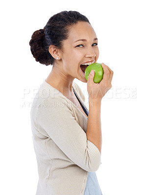 Buy stock photo Young woman smiling while eating a fresh apple - isolated on white