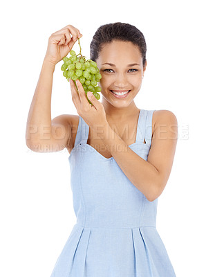 Buy stock photo Young woman smiling while holding up a bunch of grapes - isolated on white