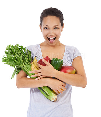 Buy stock photo Young woman smiling while holding an armful of fresh vegetables - isolated