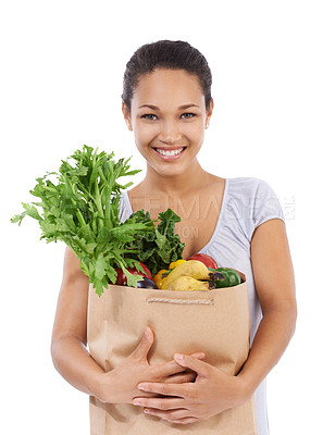 Buy stock photo Young woman smiling while holding her groceries - isolated