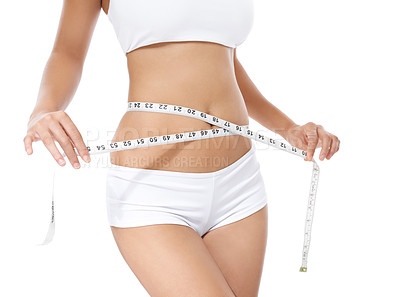 Buy stock photo Cropped image of a young woman measuring her waist