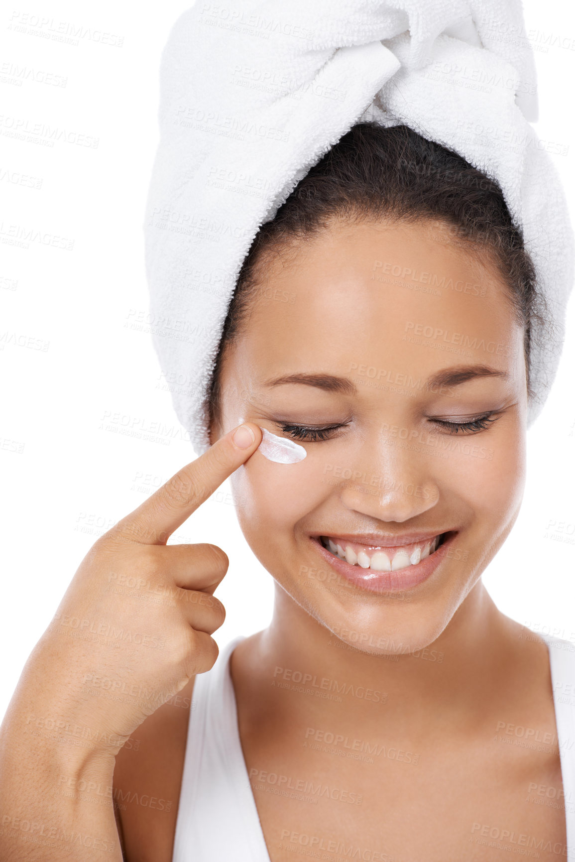 Buy stock photo Closeup of a young woman applying cream to her face