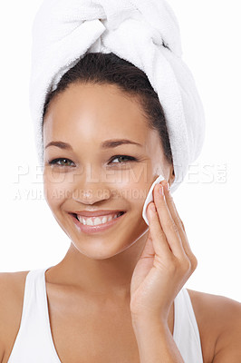 Buy stock photo Closeup of a young woman cleansing her skin with a cotton pa