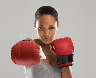 Buy stock photo Woman, portrait and boxing fighter ready for competition against a gray studio background. Face of female person or professional boxer with gloves for fitness, self defense or MMA challenge in sports