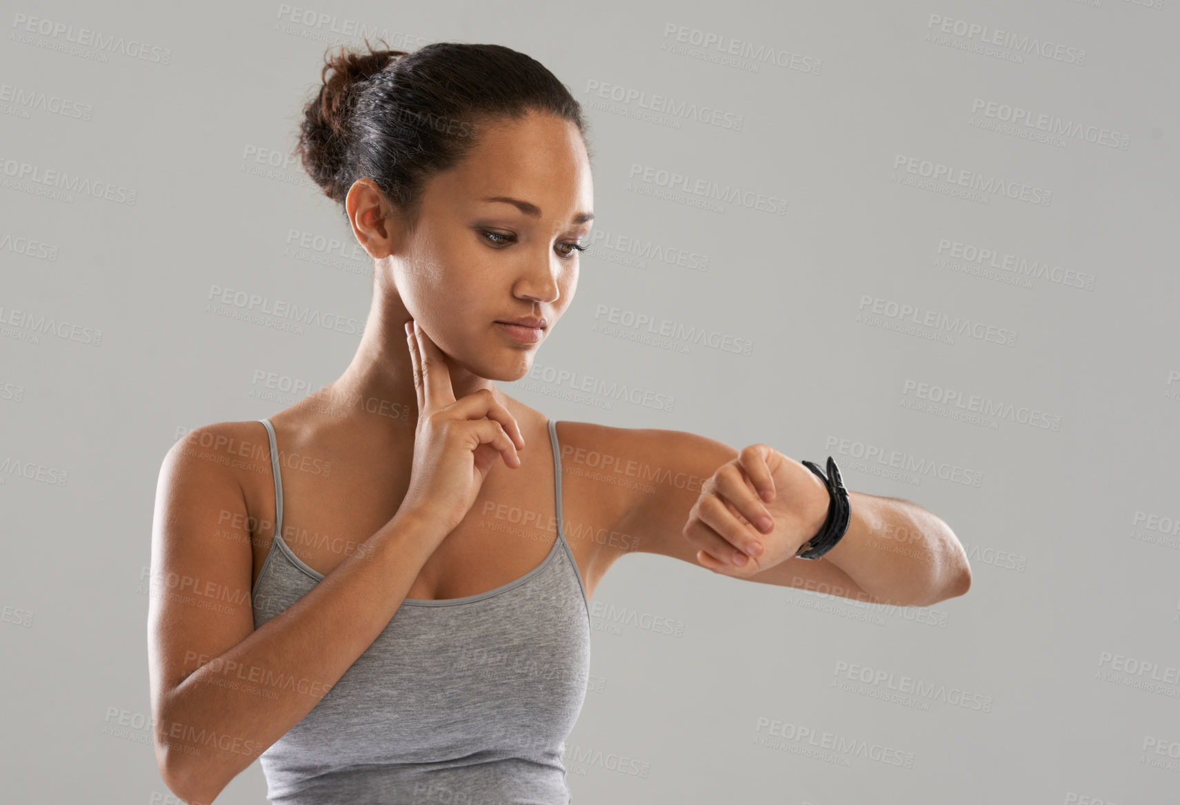 Buy stock photo Woman, watch and checking pulse on neck for monitoring heartbeat against a gray studio background. Active female person or athlete looking at wristwatch in fitness for blood pressure on mockup space