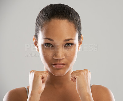 Buy stock photo Woman, portrait and fists for fight, self defense or fitness against a gray studio background. Face of female person or fighter with hands in martial arts for strength, power or protection on mockup