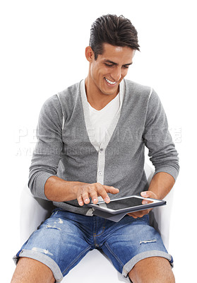 Buy stock photo Man, tablet and smile on chair in studio for social media post, reading ebook and blog on white background. Happy model scroll on digital technology for connection, download app and online shopping