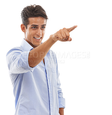 Buy stock photo A handsome young man pointing his finger and smiling against a white background