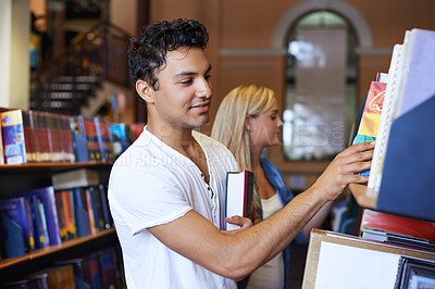 Buy stock photo Student, book and man in a library to search at university, college or school campus for education. Bookshelf, learning or male person with scholarship studying knowledge, research and information