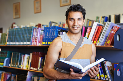 Buy stock photo Reading book, portrait or happy man in library at university, college or school campus for education. Bookshelf, learning or male student with scholarship studying knowledge, research or information