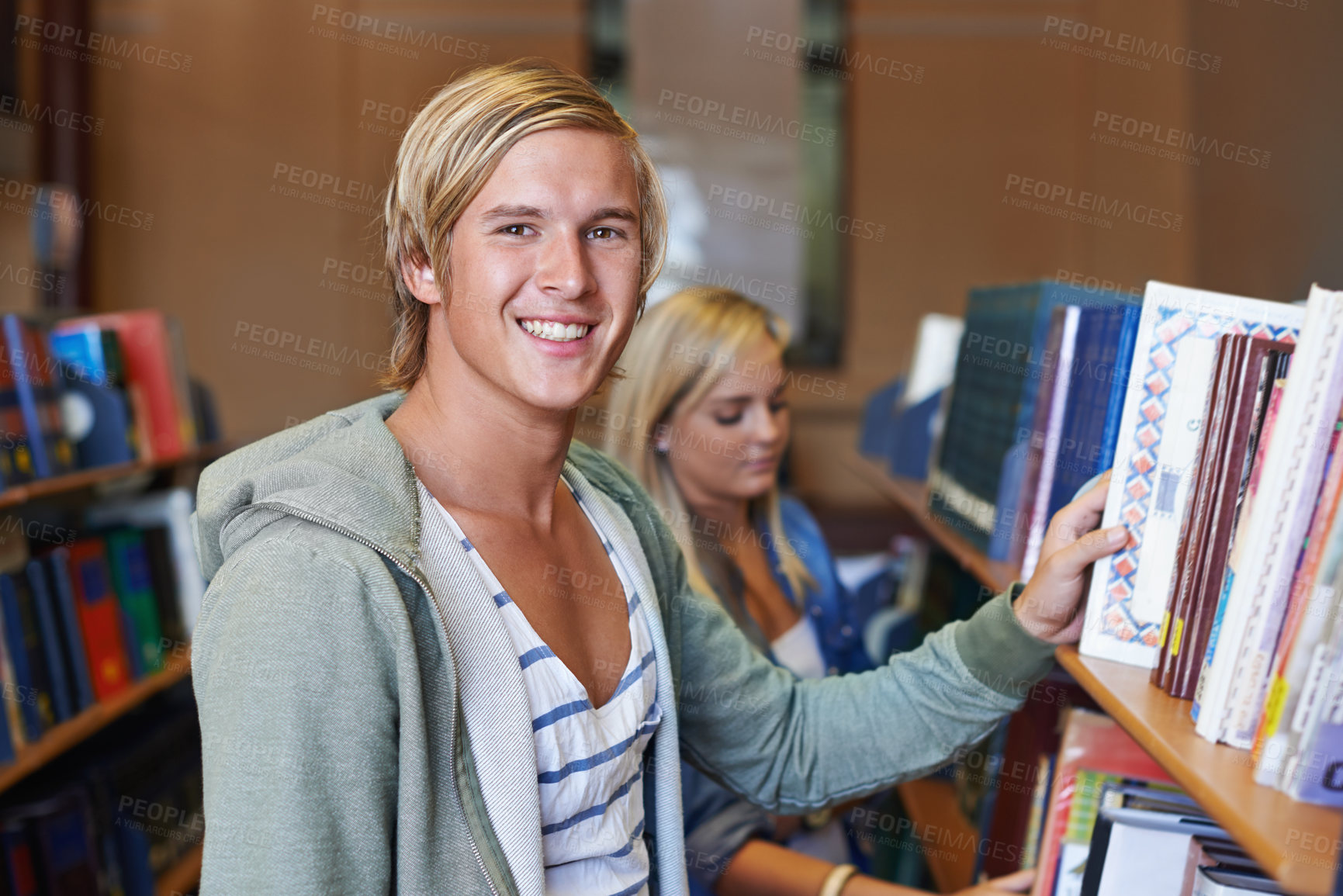 Buy stock photo Portrait, book or happy man in library to search at university, college or school campus for education. Bookshelf, learning or student with scholarship studying knowledge, research and information 