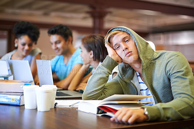 Buy stock photo Tired, study group or portrait of student in library with burnout, depression or low energy. Lazy man, university or exhausted person bored by books with fatigue or adhd with people for teamwork