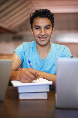 Buy stock photo Portrait of a handsome young student studying for his exams