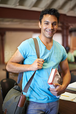 Buy stock photo Classroom, man or college student with book, portrait or studying for knowledge, development or academy. Person, bag and learning process with smile for pride, scholarship or education for assessment