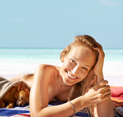 Buy stock photo Woman, portrait and happy on beach and sunbathing with dog, vacation and travel to Hawaii. Female person, resting and tanning on sand and peaceful by water, nature and wellness by ocean and animal