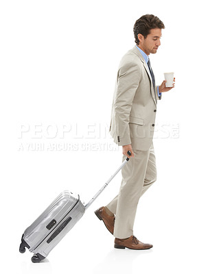 Buy stock photo Studio shotof a young businessman walking with a suitcase and coffee isolated on white