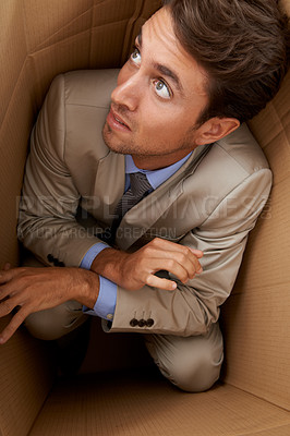 Buy stock photo Businessman, trapped and box at work with frustrated, scared and fear in office for career or startup. Entrepreneur, corporate and person isolated in cardboard at workplace with stress and anxiety