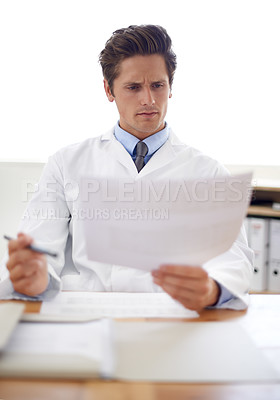 Buy stock photo Reading, document and portrait of man doctor in the office for consultation in a medical hospital. Serious, report and professional young male healthcare worker with paperwork for research in clinic.