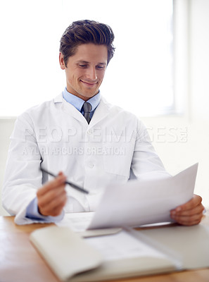 Buy stock photo Happy, document and portrait of man doctor in the office for consultation in a medical hospital. Smile, reading and professional young male healthcare worker with paperwork for research in a clinic.