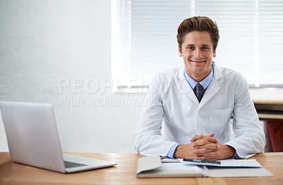 Buy stock photo Portrait of a smiling doctor sitting at his desk