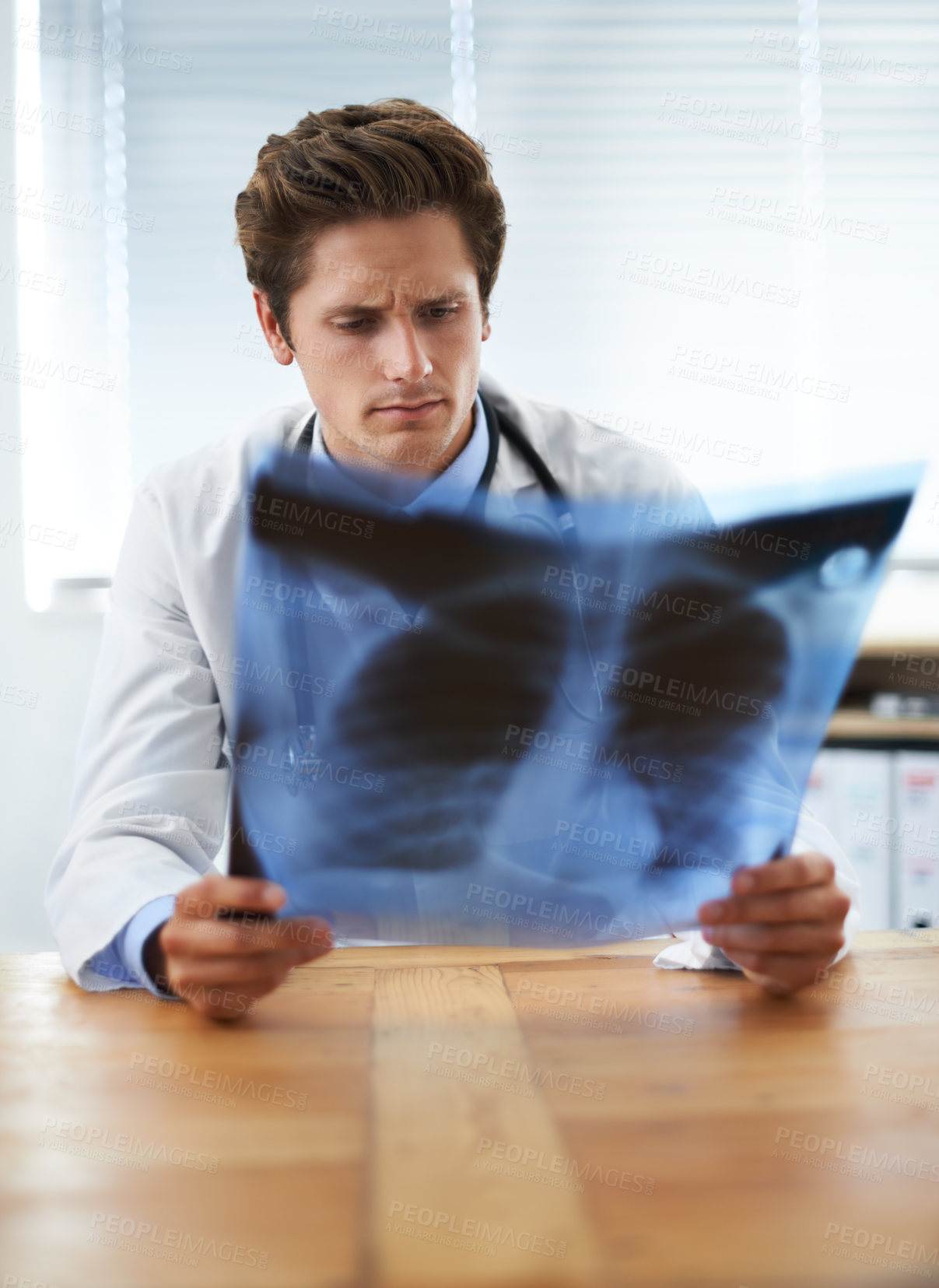 Buy stock photo Man doctor in office and check xray, healthcare with medical diagnosis and review of lung scan at cardiology clinic. Radiology, surgeon thinking in doubt after assessment of results with MRI