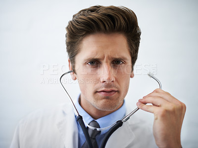 Buy stock photo Serious, stethoscope and portrait of doctor in his office for medical concern at hospital. Doubt, thinking or worried and handsome professional male healthcare worker working at medicare clinic.