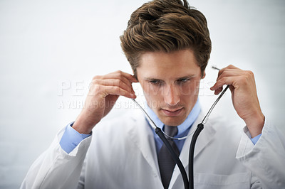 Buy stock photo Serious, stethoscope and young doctor with medical career in cardiology at medicare hospital. Doubt, thinking and professional male healthcare worker, employee or intern with equipment in clinic.
