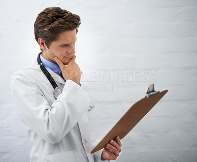 Buy stock photo Clipboard, thinking and man doctor in office for reading or brainstorming for diagnosis treatment. Ideas, checklist and professional young male healthcare worker with decision face at hospital