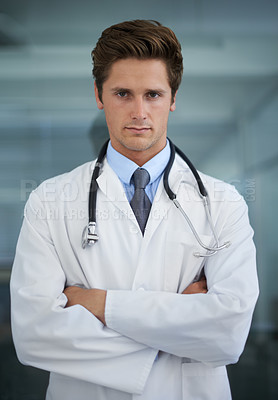 Buy stock photo Serious, crossed arms and portrait of man doctor with stethoscope for confident attitude. Career, pride and professional young male healthcare worker in medical office of hospital or clinic.