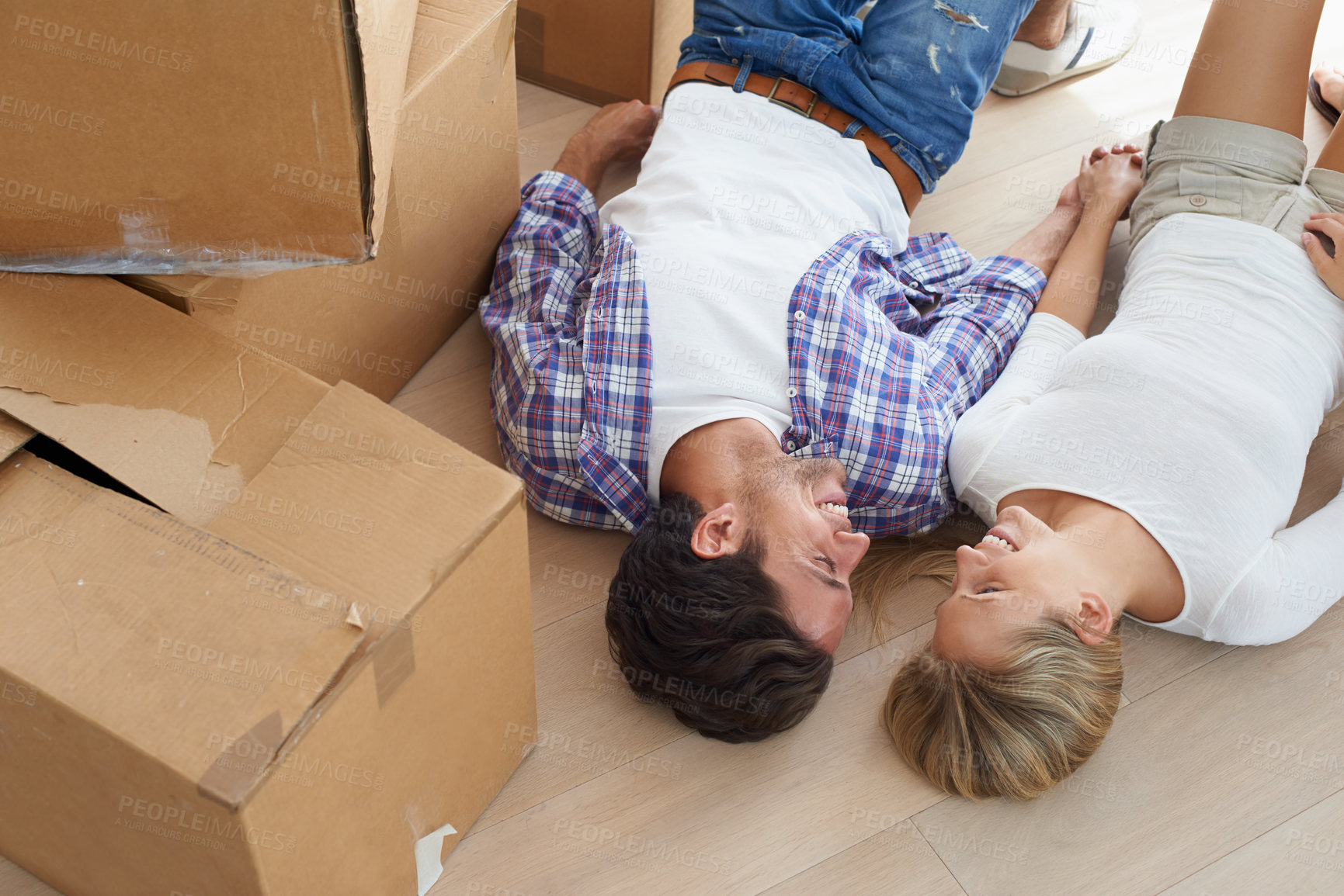 Buy stock photo Couple, boxes and smile on floor for real estate, new home or property investment with romance or love. Moving, man and woman with happy and holding hands for fresh start, achievement and dream house